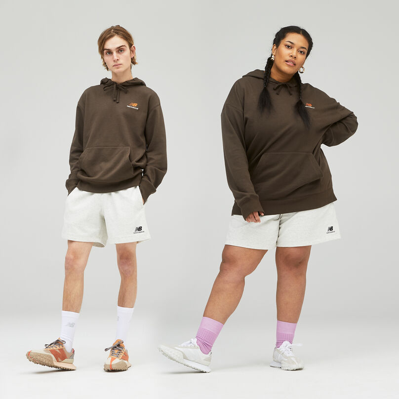 Male and female standing next to each other on a grey background.